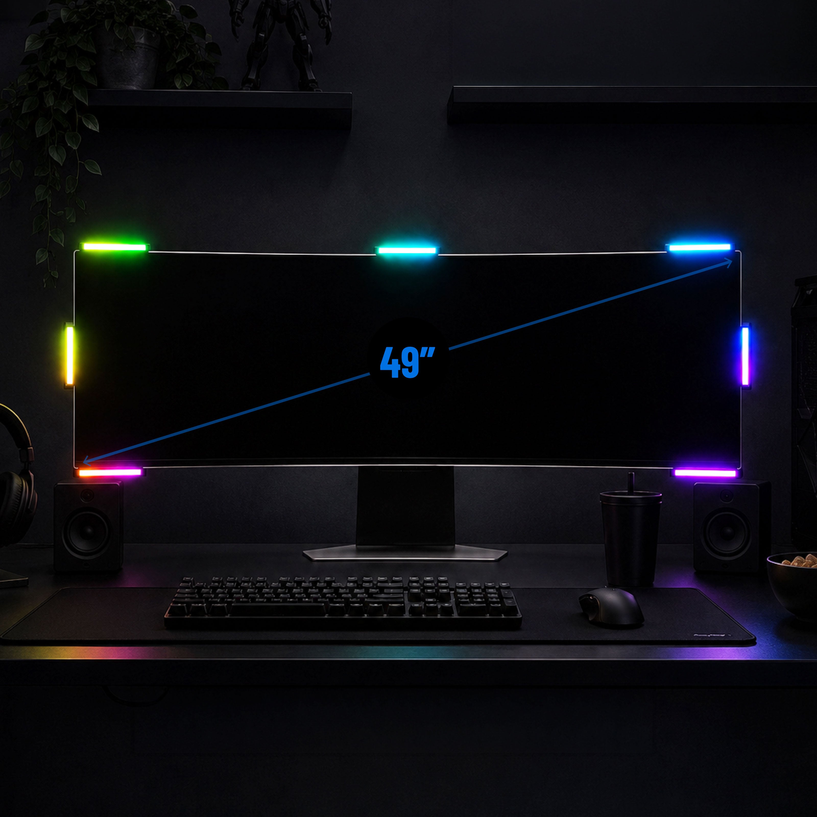 A 49-inch ultra-wide curved gaming monitor with vibrant RGB lighting strips around the edges, displayed on a desk setup with a keyboard, mouse, speakers, and a cup in a dark room.